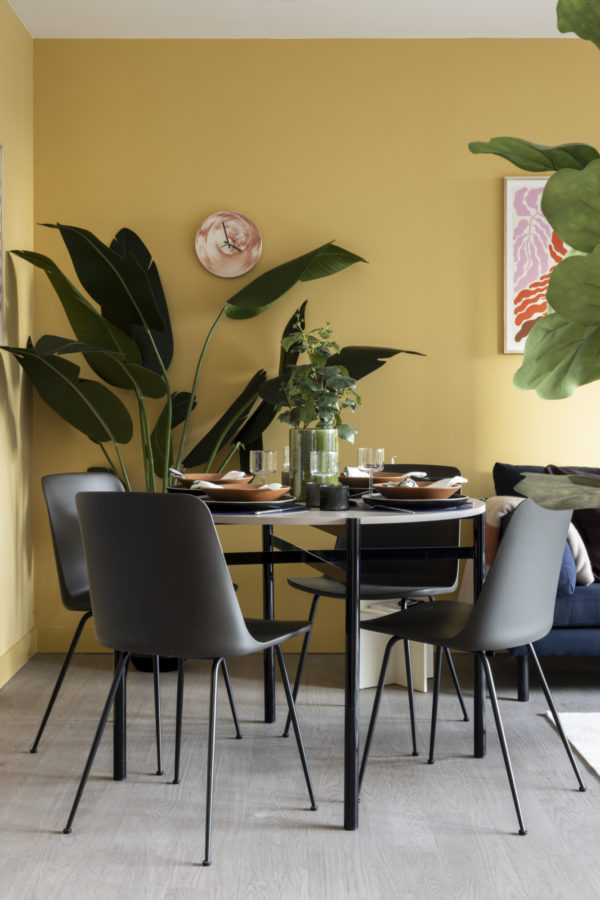 An apartment dining setting, with circular table and four chairs, by &tradition